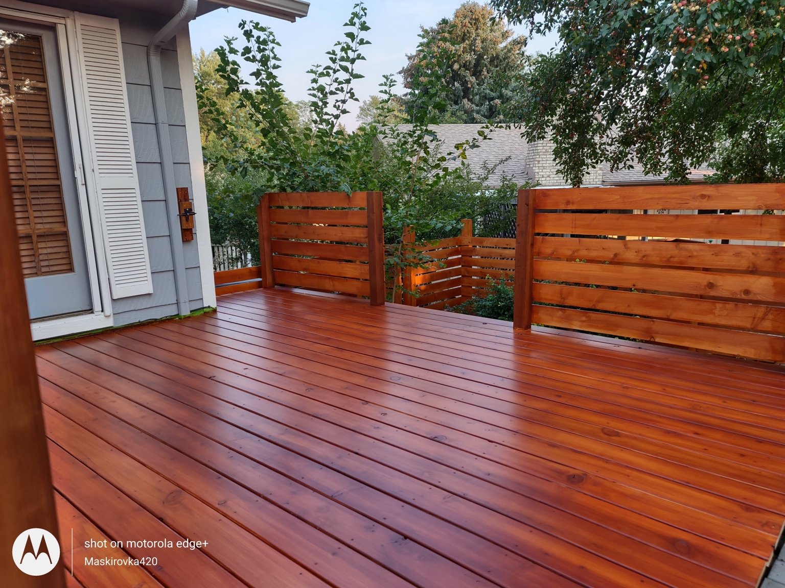 Warm-toned wooden deck with custom horizontal wood railing