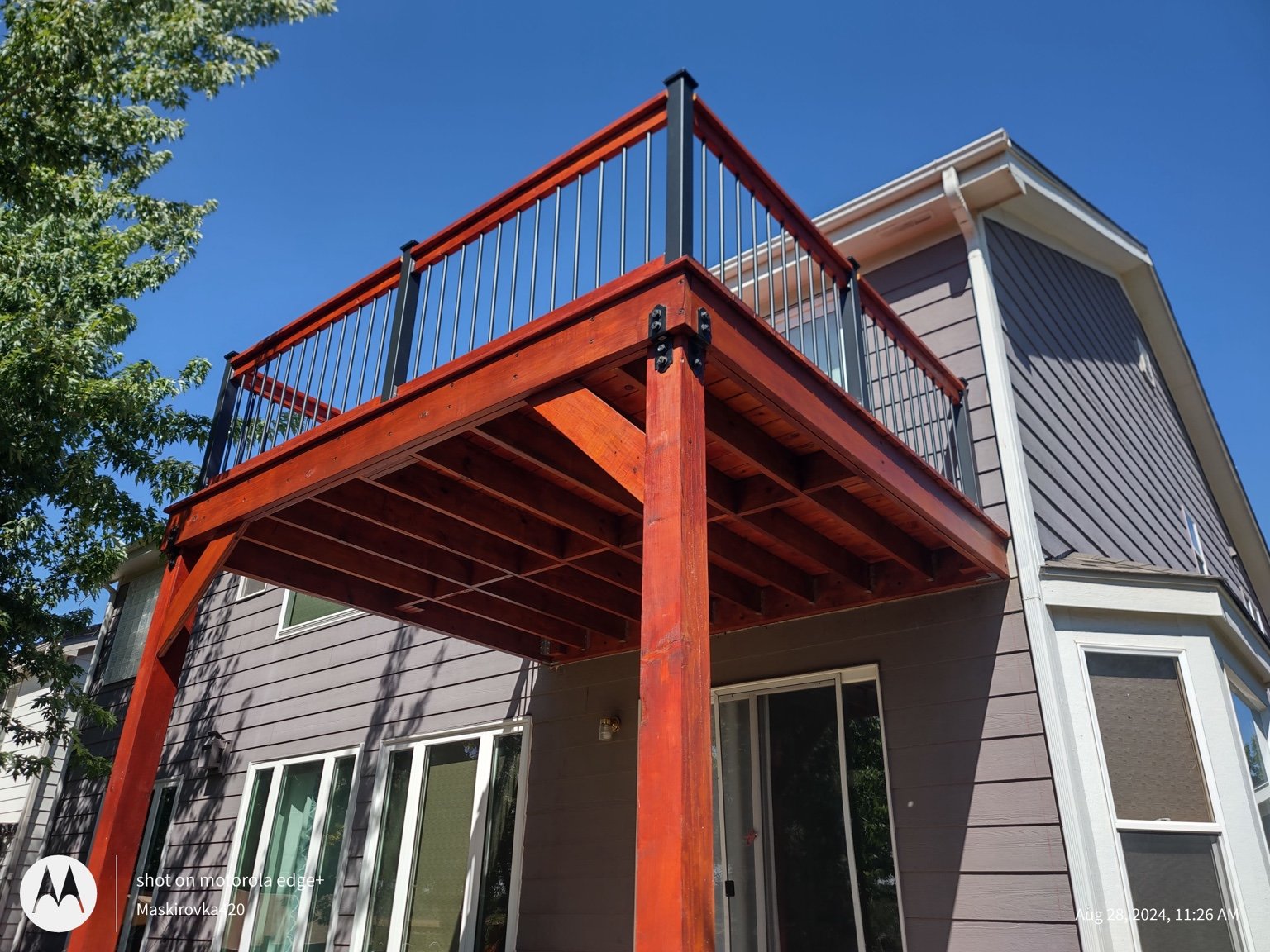 Elevated wooden deck with metal balusters